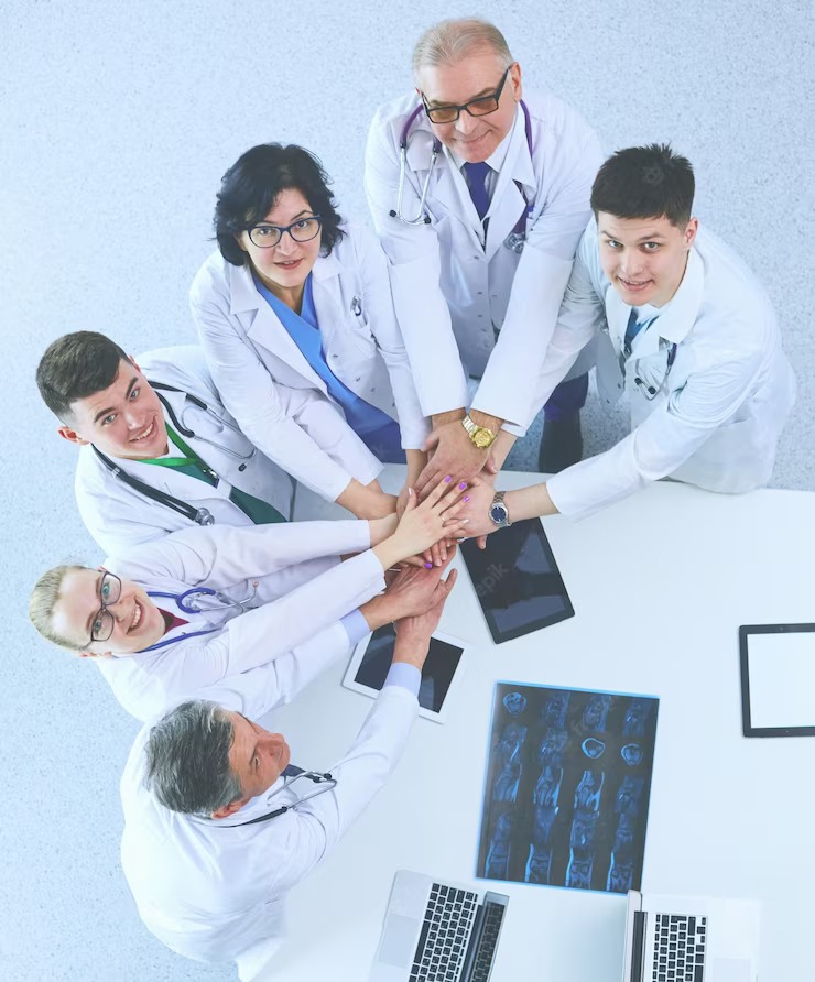 medical-team-sitting-discussing-table-top-view_358354-16559